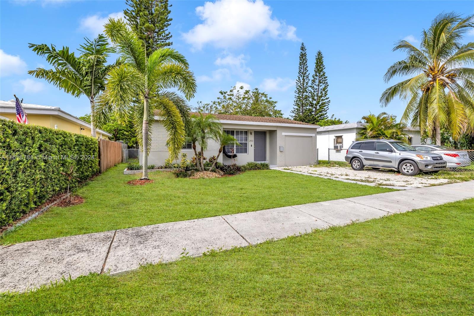 243 Southwest 9th Street Dania Beach, FL 33004 - Photo 7 of 31 a view of a house with a big yard and palm trees