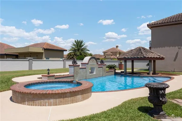 a view of a house with backyard and sitting area