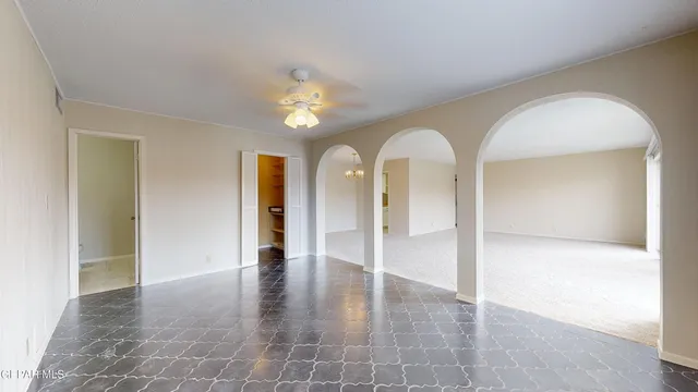 an empty room with an entryway and wooden floor