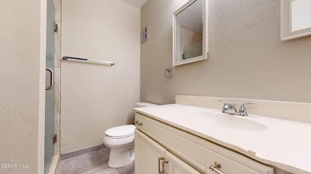 a kitchen with stainless steel appliances granite countertop a refrigerator a stove and a sink