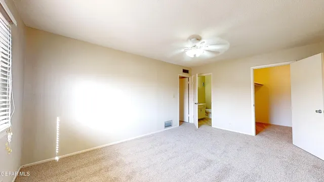a white kitchen with a table and chairs in it