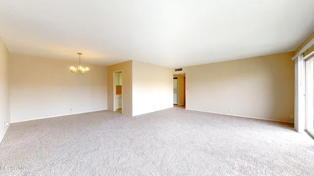 a view of a chandelier in big room and chandelier
