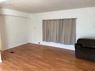 a view of a room with wooden floor