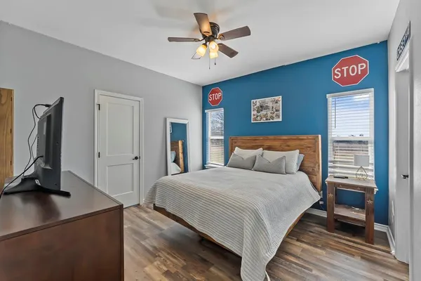 a bedroom with a bed and a chandelier