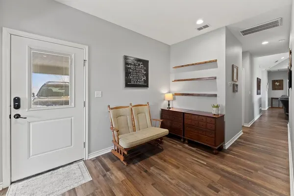 a living room with furniture and wooden floor
