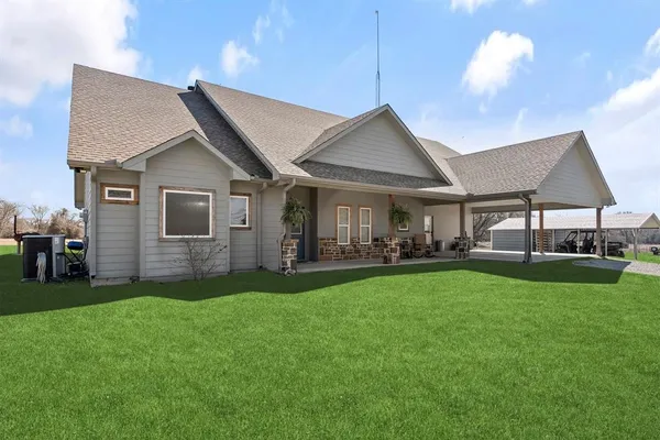 a front view of a house with a garden and patio
