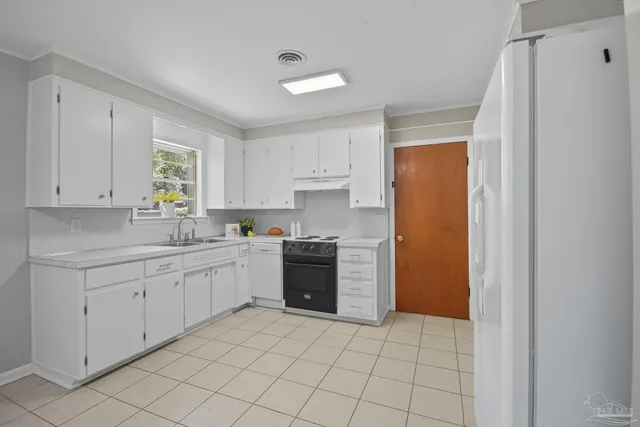 a kitchen with granite countertop white cabinets and sink