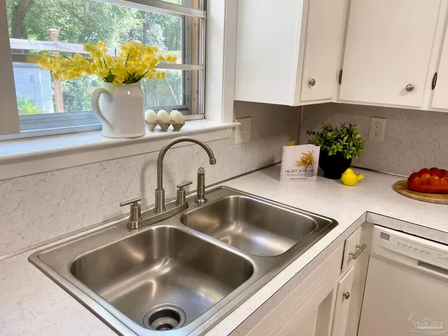 a kitchen with white cabinets and white appliances