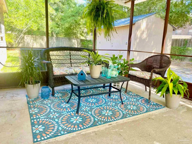 a balcony with furniture and garden view
