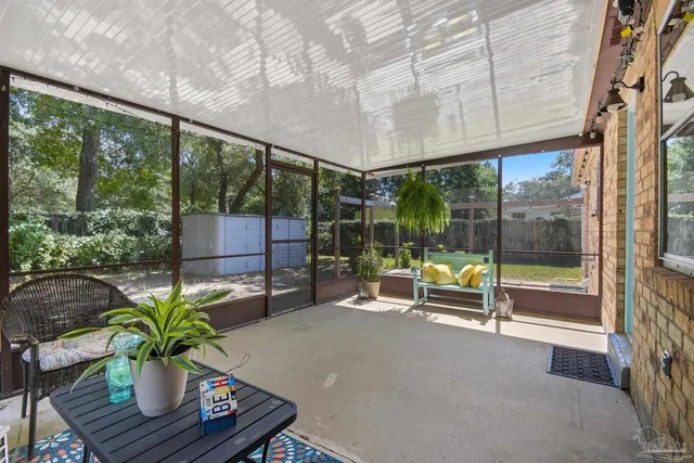 a living room with a floor to ceiling window and pool table