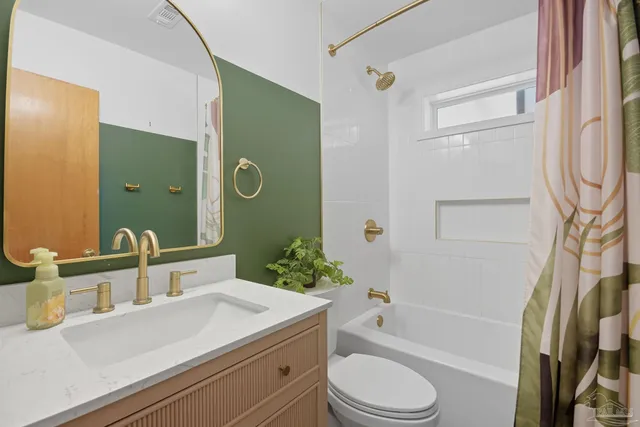 a bathroom with a sink mirror and vanity