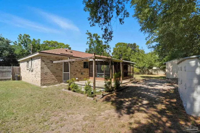 a backyard of a house with a tree