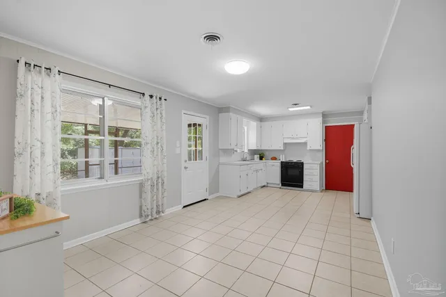a view of a kitchen with white cabinets and white appliances