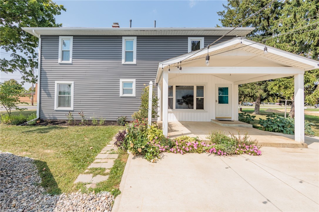 Rear view of house with a yard