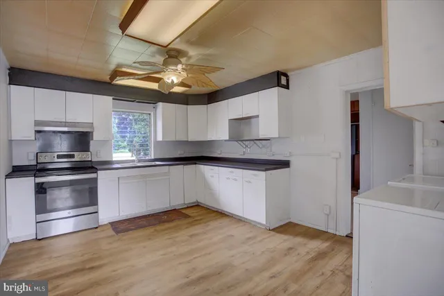 a kitchen with a sink cabinets and window