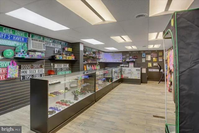 a kitchen with stainless steel appliances kitchen island granite countertop a stove refrigerator and cabinets