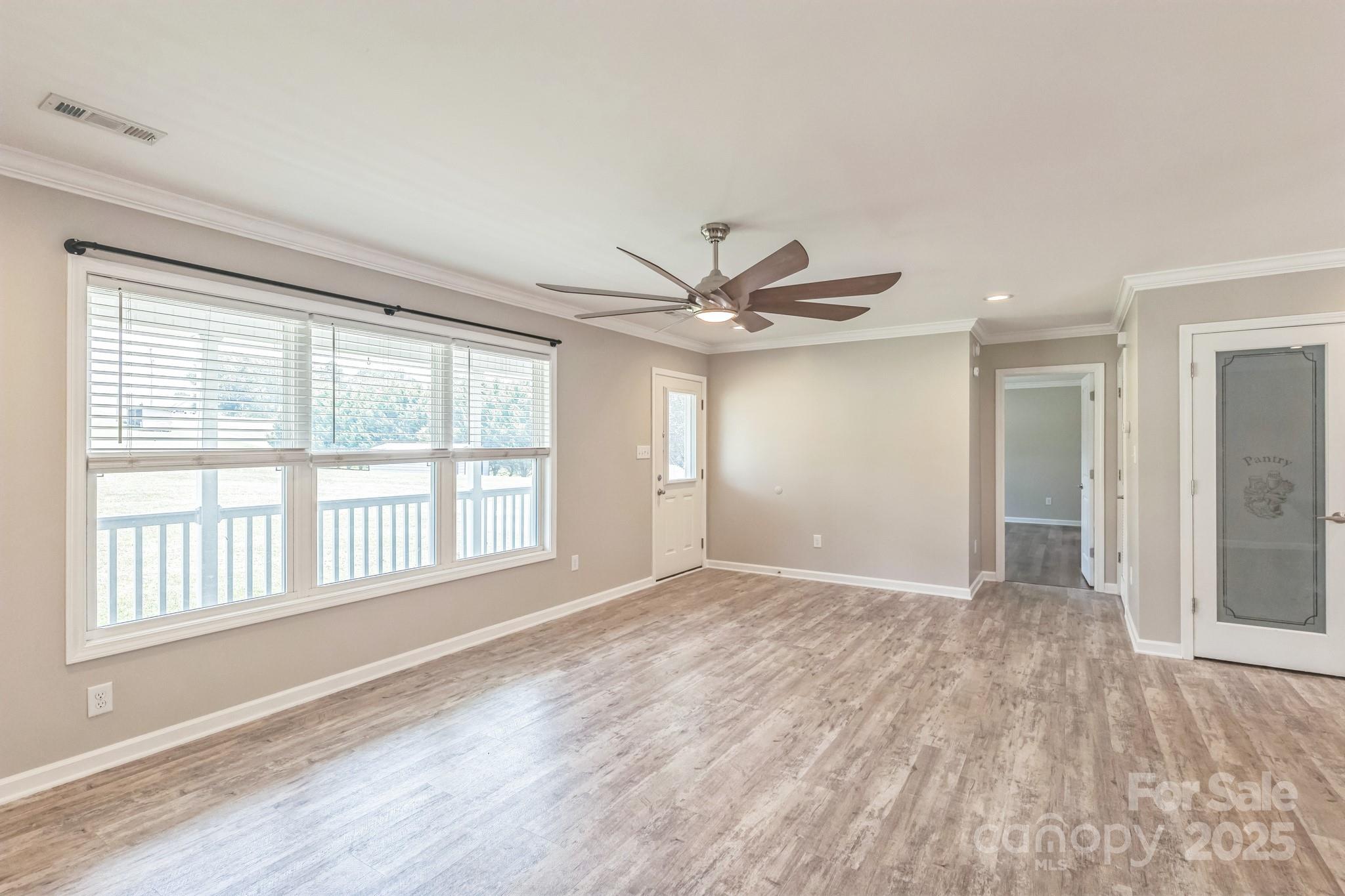 1259 Hardin Road Dallas, NC 28034 - Photo 4 of 16 a view of an empty room with a window and wooden floor