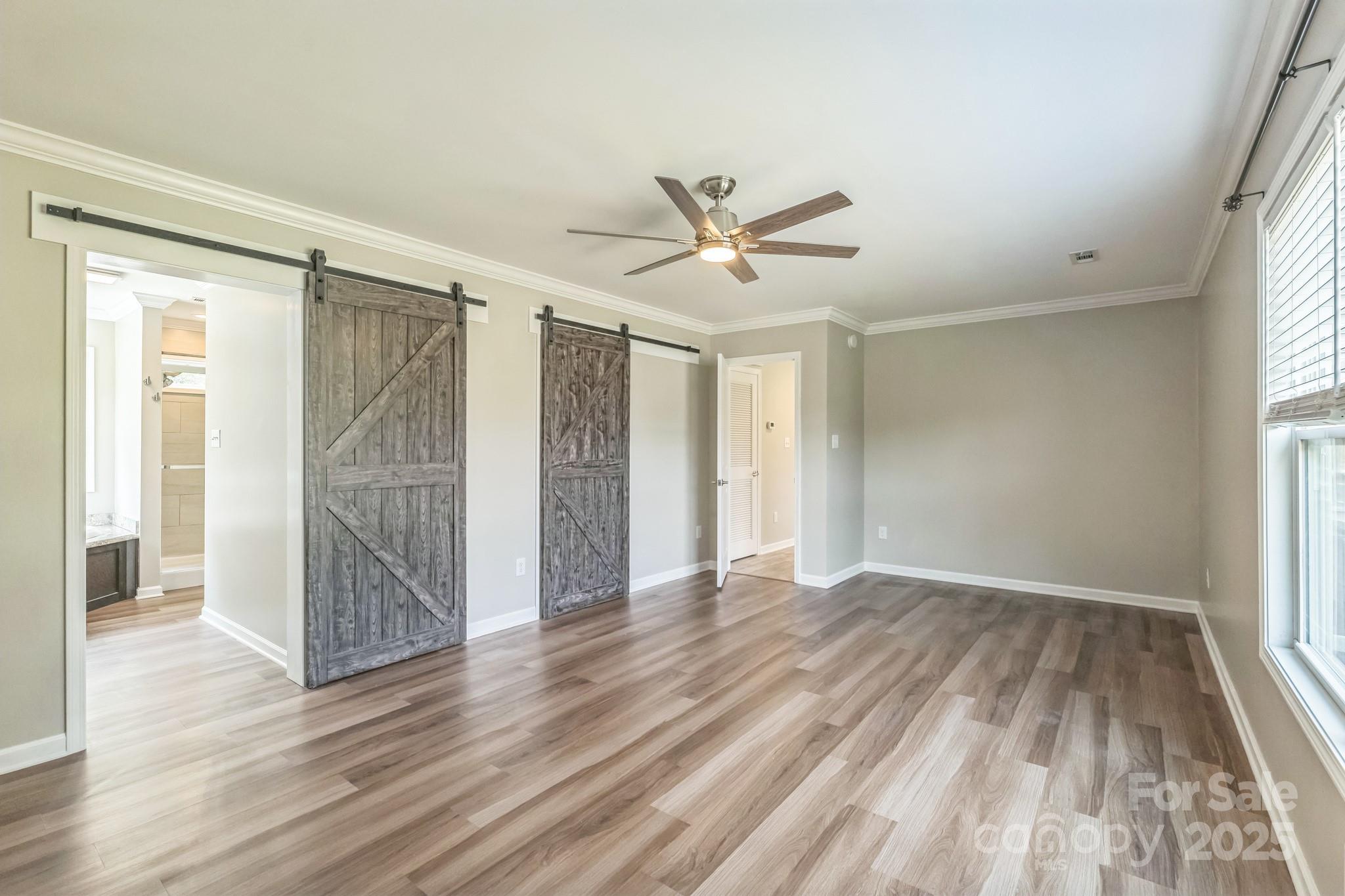 1259 Hardin Road Dallas, NC 28034 - Photo 8 of 16 an empty room with wooden floor and windows