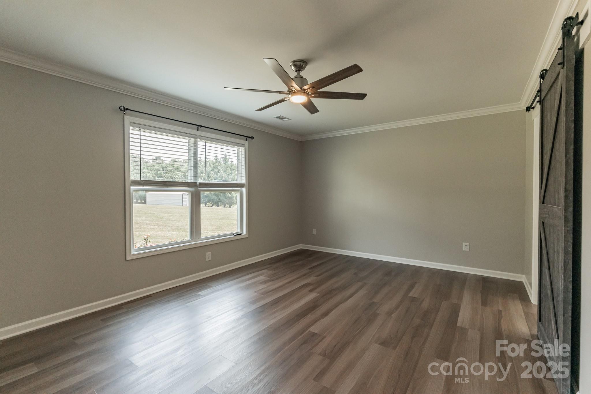 1259 Hardin Road Dallas, NC 28034 - Photo 9 of 16 a view of an empty room with wooden floor and a window