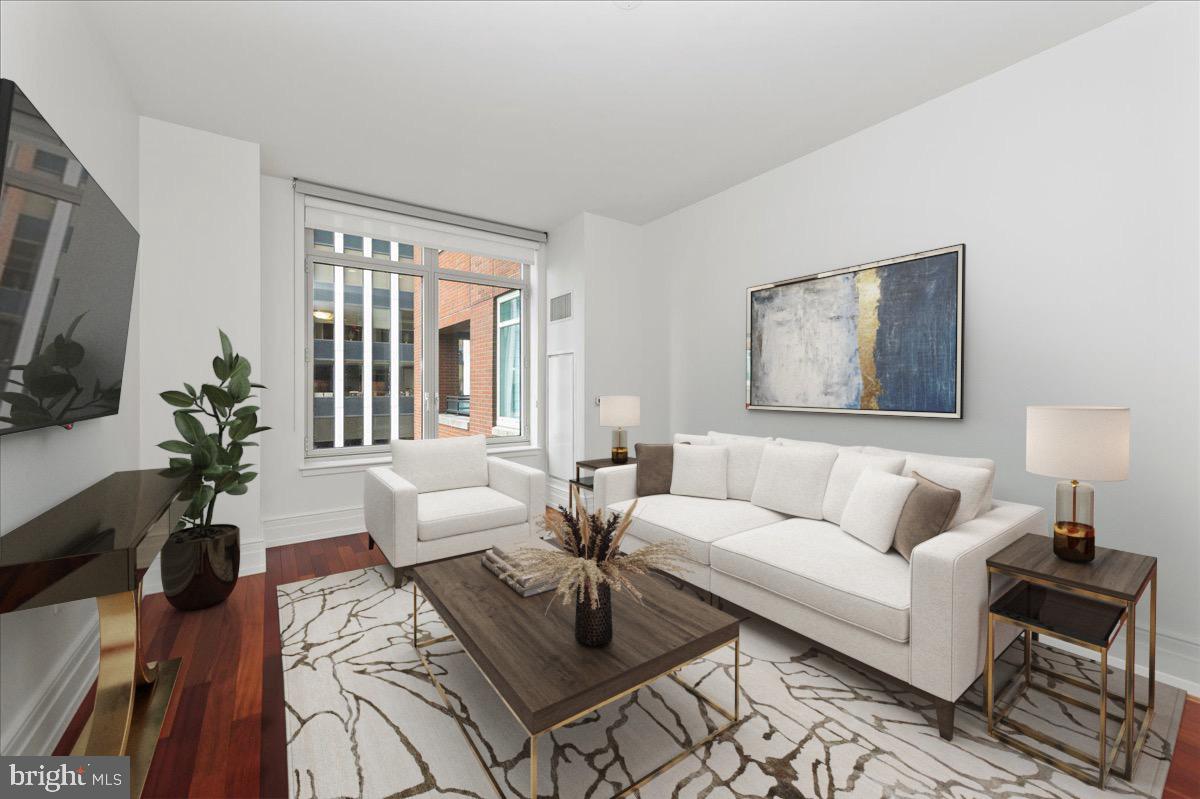 a living room with furniture a flat screen tv and a large window