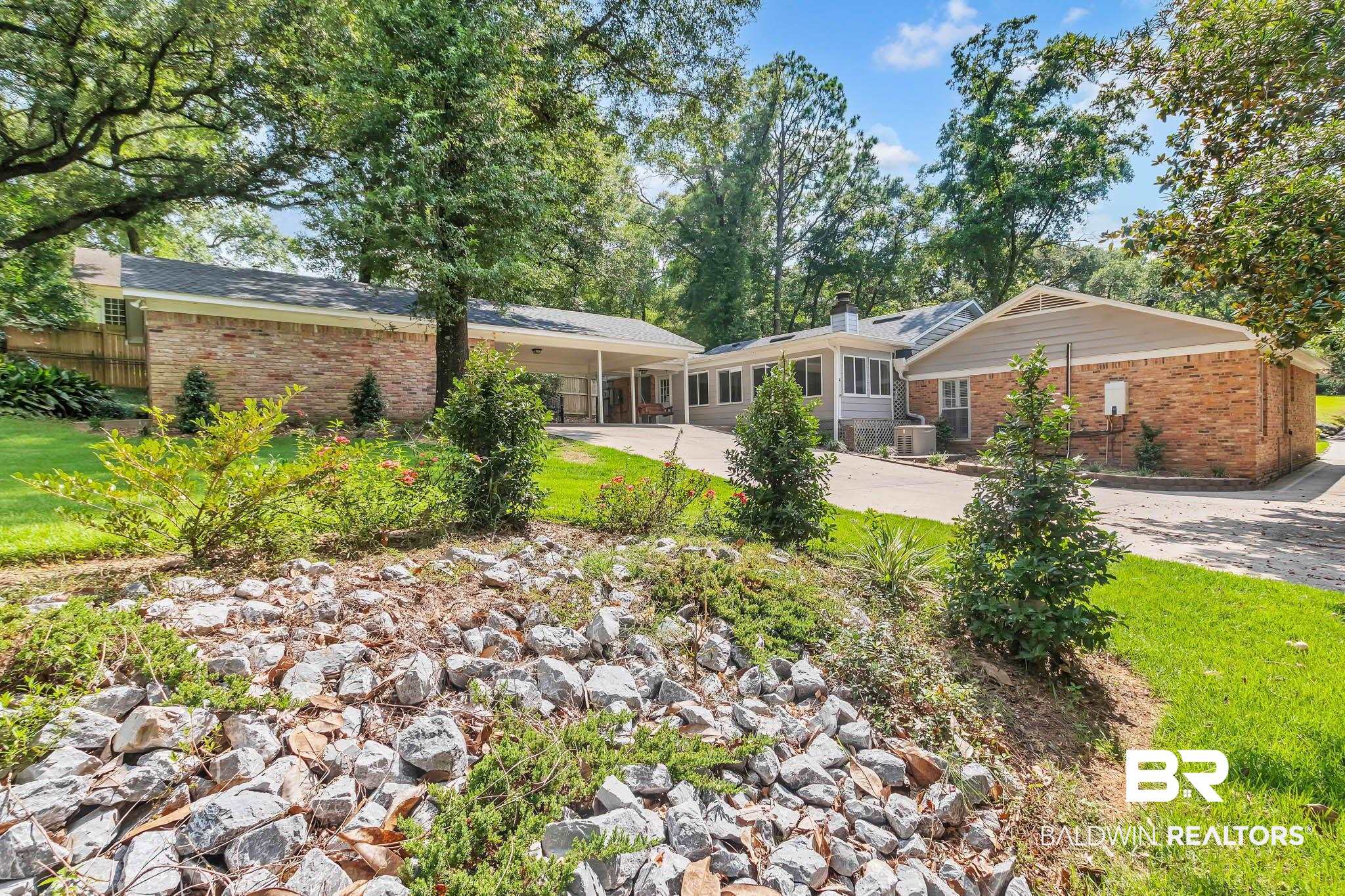 309 West Brandy Run Road Mobile, AL 36608 - Photo 88 of 100 Back of house featuring brick siding, concrete driveway, and a yard