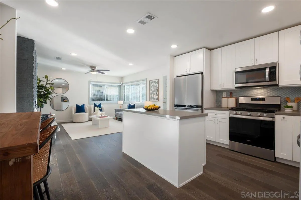 941 8th Street Imperial Beach, CA 91932 - Photo 7 of 22 a kitchen with stainless steel appliances granite countertop a refrigerator stove microwave and cabinets