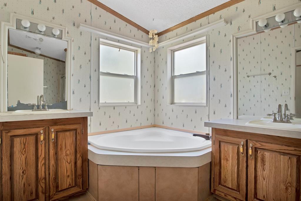 318 Bavarian Road Waco, TX 76705 - Photo 17 of 26 a bathroom with a sink and a mirror