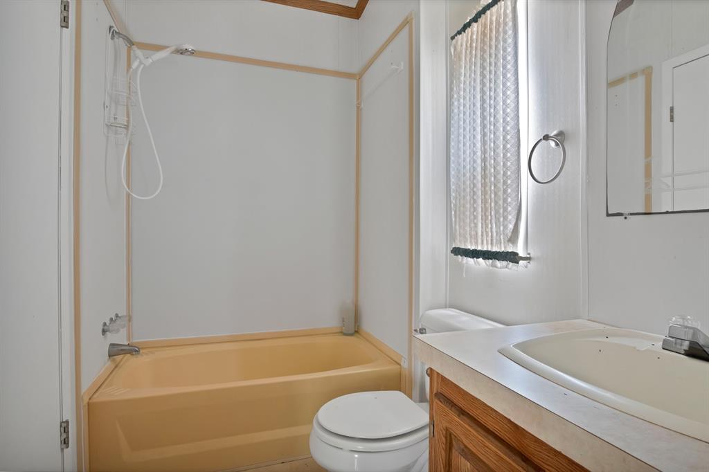 318 Bavarian Road Waco, TX 76705 - Photo 21 of 26 a bathroom with a granite countertop bathtub shower sink vanity and toilet