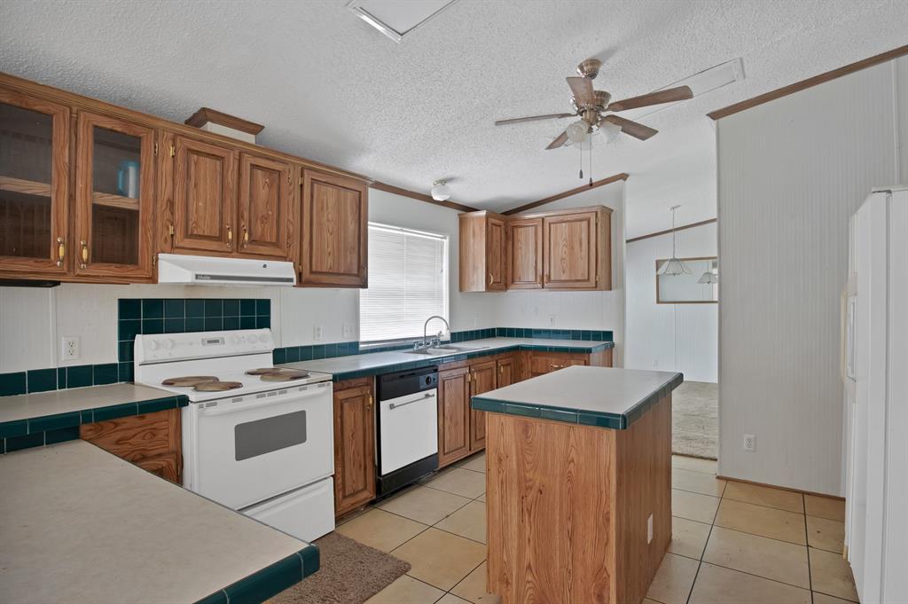 318 Bavarian Road Waco, TX 76705 - Photo 7 of 26 a kitchen with stainless steel appliances granite countertop a sink stove and refrigerator