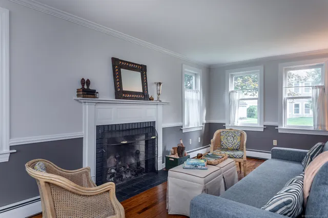 a living room with furniture a fireplace and window