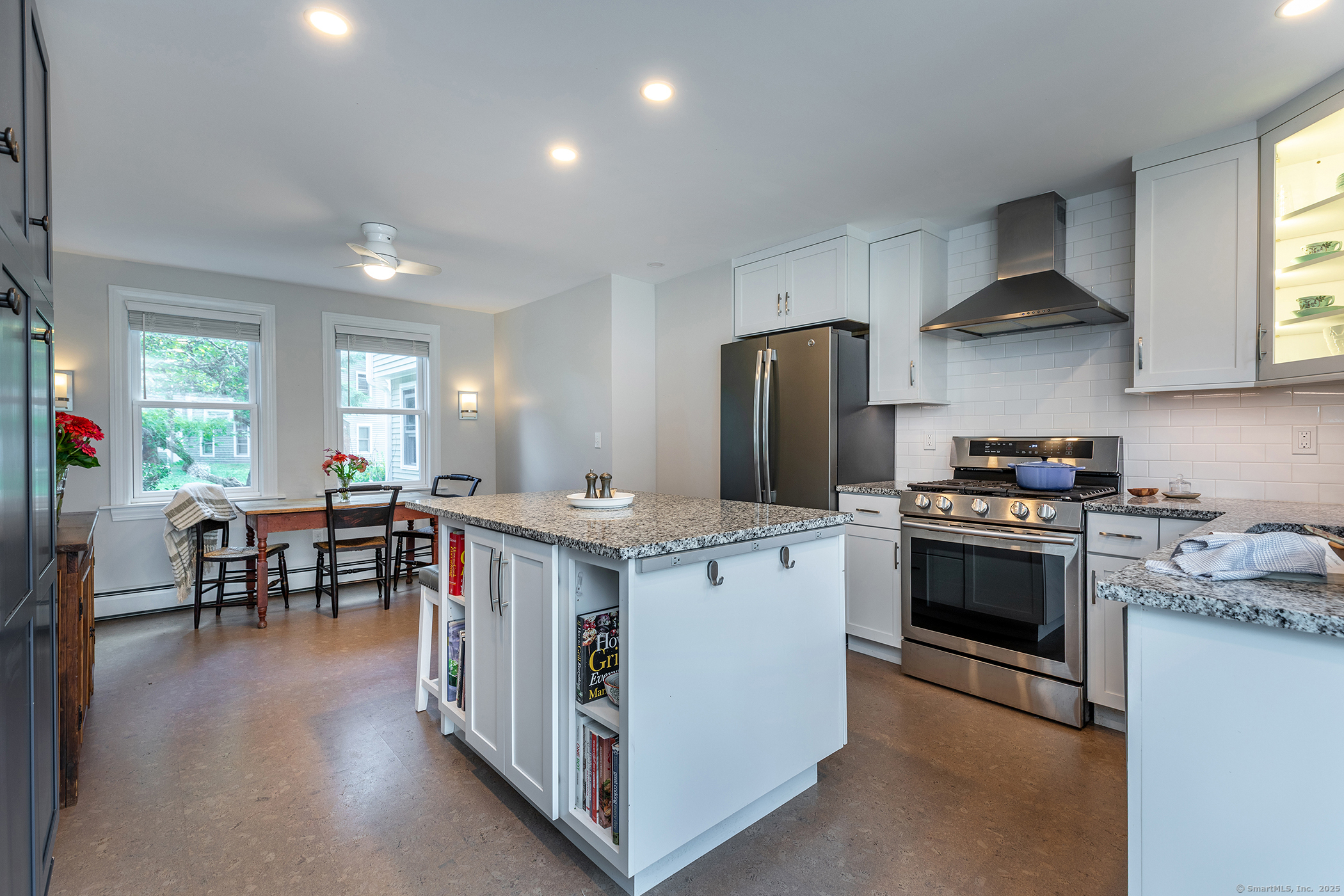 87 Canaan Road, Unit 2G Salisbury, CT 06068 - Photo 2 of 30 a kitchen with stainless steel appliances a stove a sink a oven a dining table and chairs