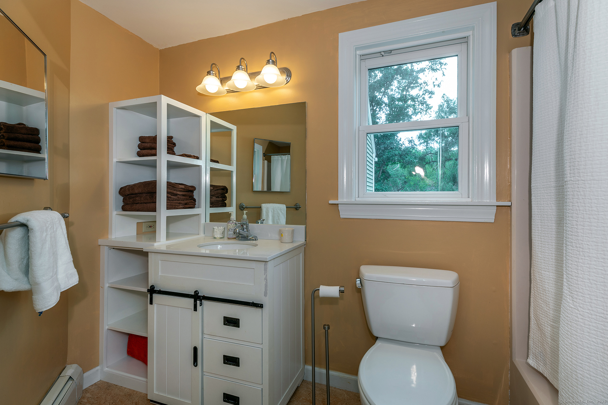 87 Canaan Road, Unit 2G Salisbury, CT 06068 - Photo 22 of 30 a bathroom with a toilet sink and mirror