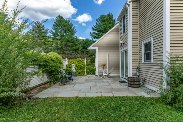 a wooden bench sitting in front of a house