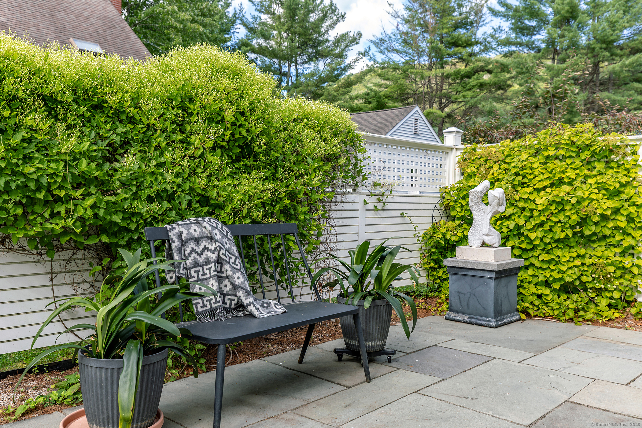 87 Canaan Road, Unit 2G Salisbury, CT 06068 - Photo 24 of 30 a wooden bench sitting in front of a house