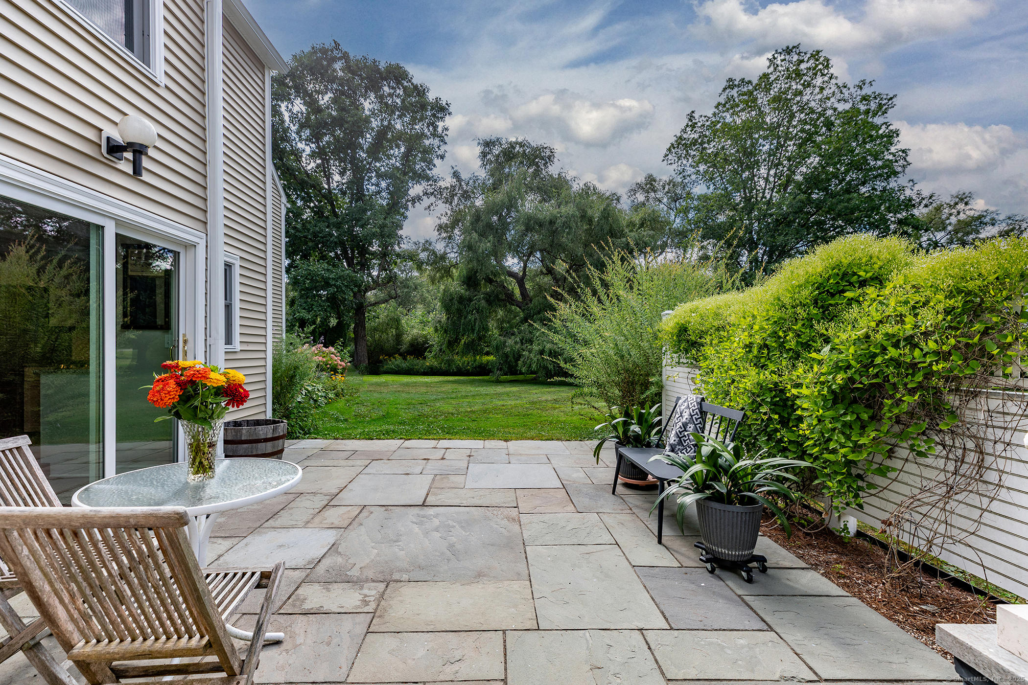 87 Canaan Road, Unit 2G Salisbury, CT 06068 - Photo 25 of 30 a view of a chair and tables in the patio with a barbeque grill