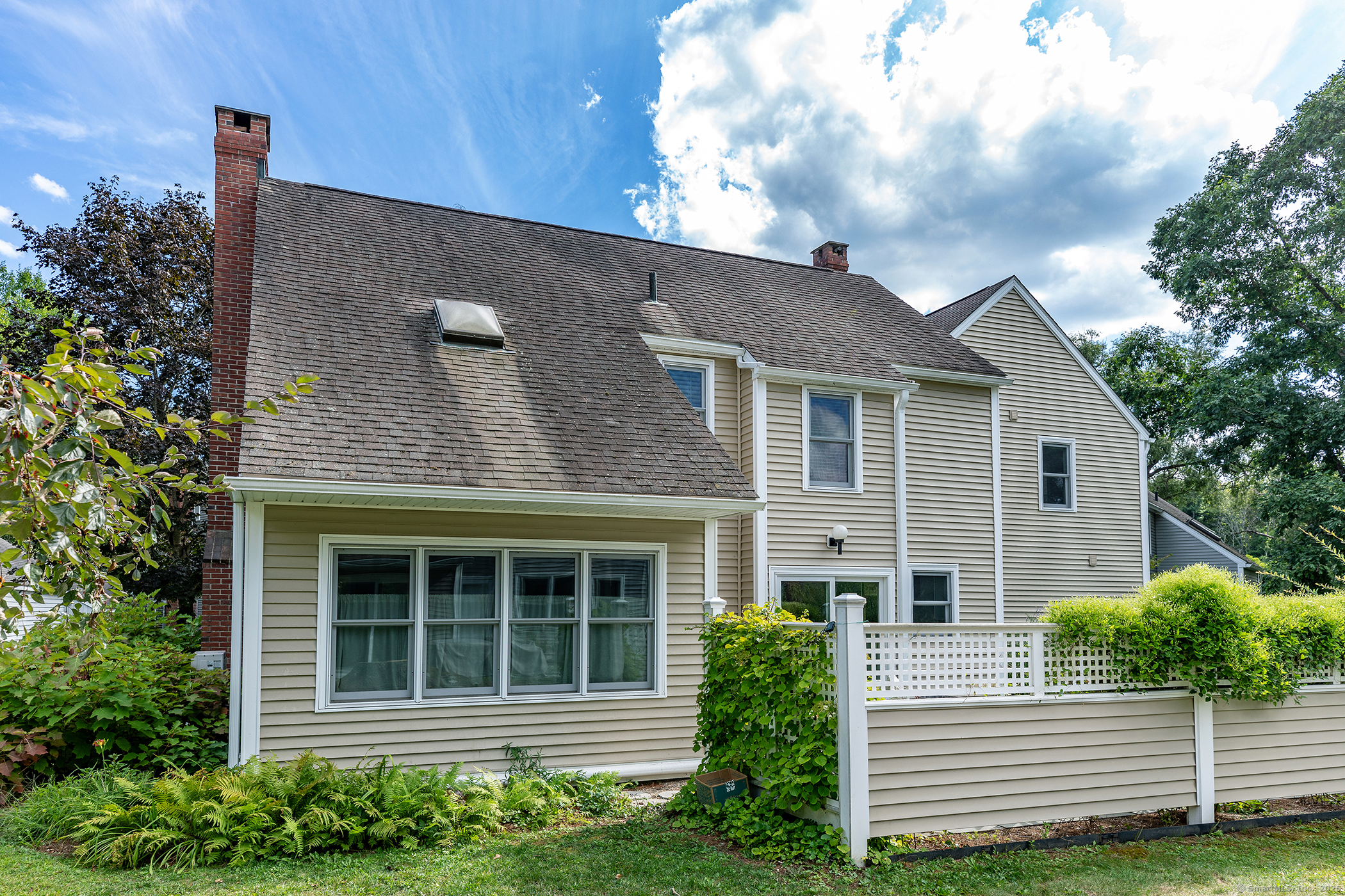 87 Canaan Road, Unit 2G Salisbury, CT 06068 - Photo 29 of 30 a view of brick house with windows and plants