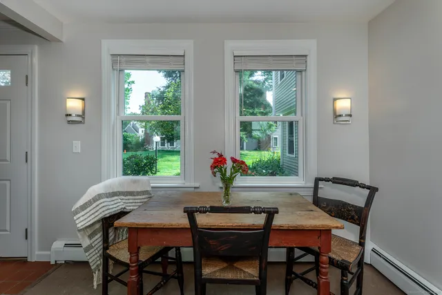 a dining room with a wooden table and chairs