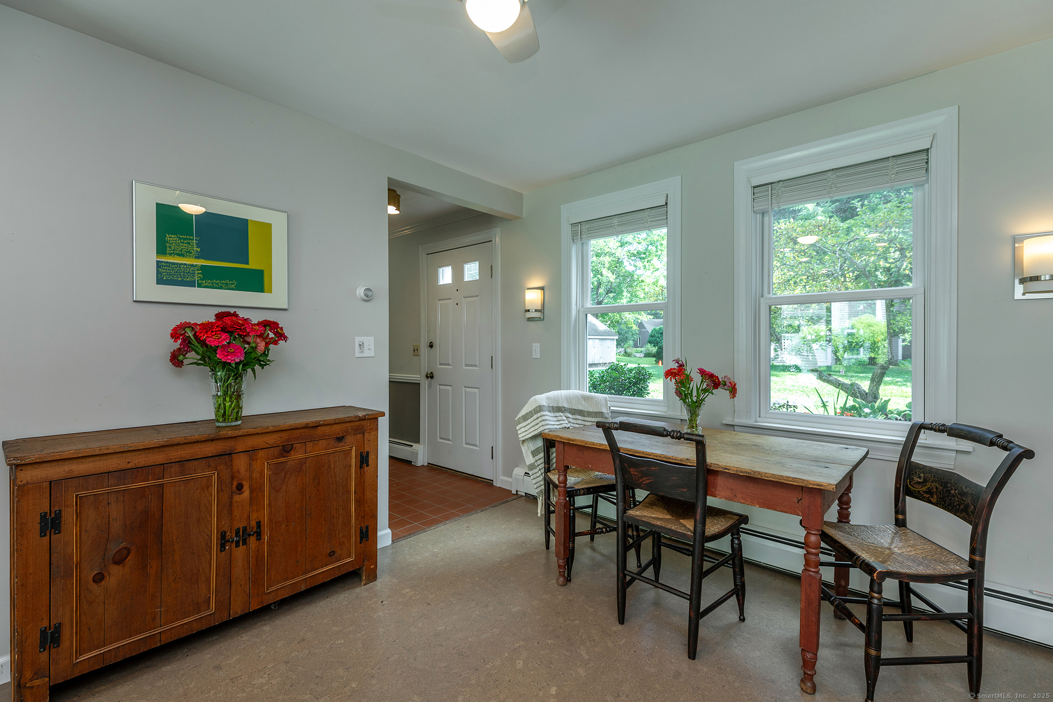 87 Canaan Road, Unit 2G Salisbury, CT 06068 - Photo 7 of 30 a dining room with furniture potted plants and wooden floor