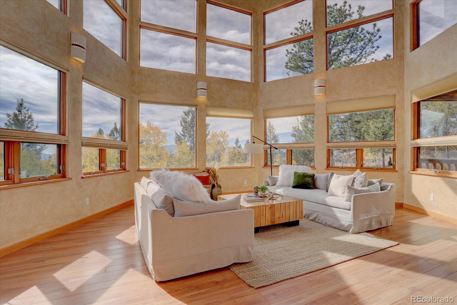 12227 Calfee Gulch Road Conifer, CO 80433 - Photo 11 of 43 a living room with furniture or large windows