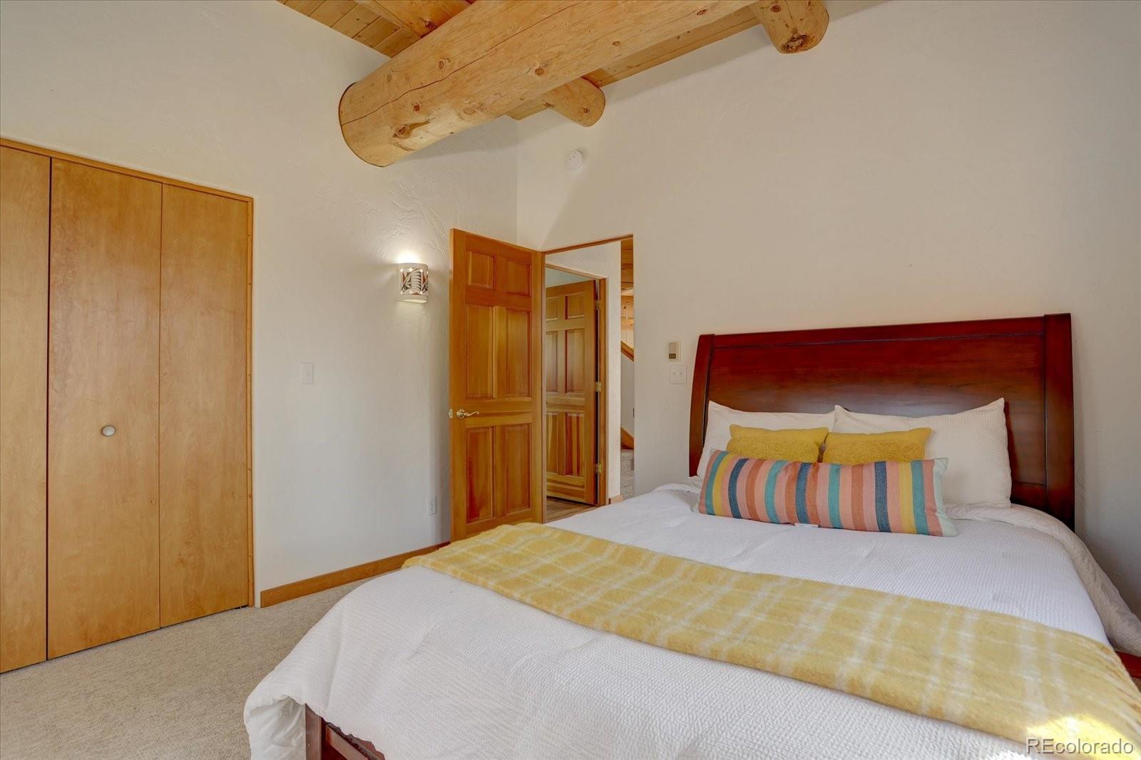 12227 Calfee Gulch Road Conifer, CO 80433 - Photo 17 of 43 a bedroom with a bed and closet