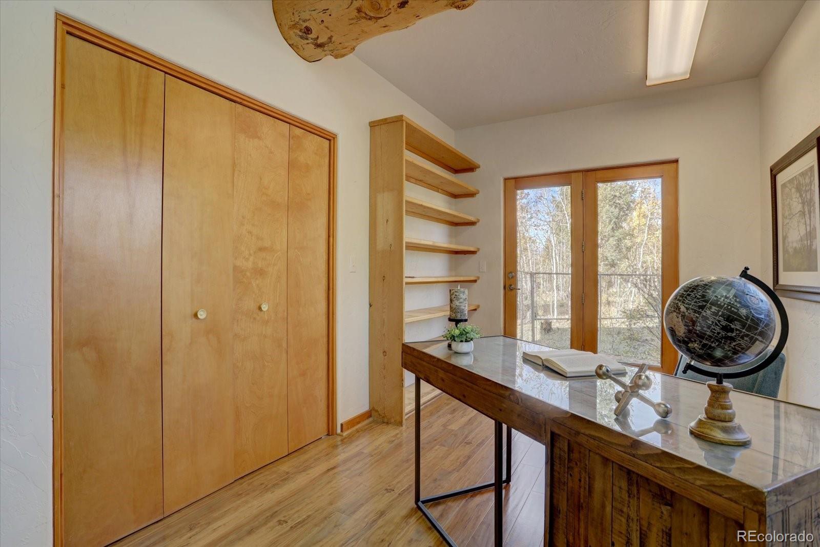 12227 Calfee Gulch Road Conifer, CO 80433 - Photo 19 of 43 a view of a hallway with furniture and windows