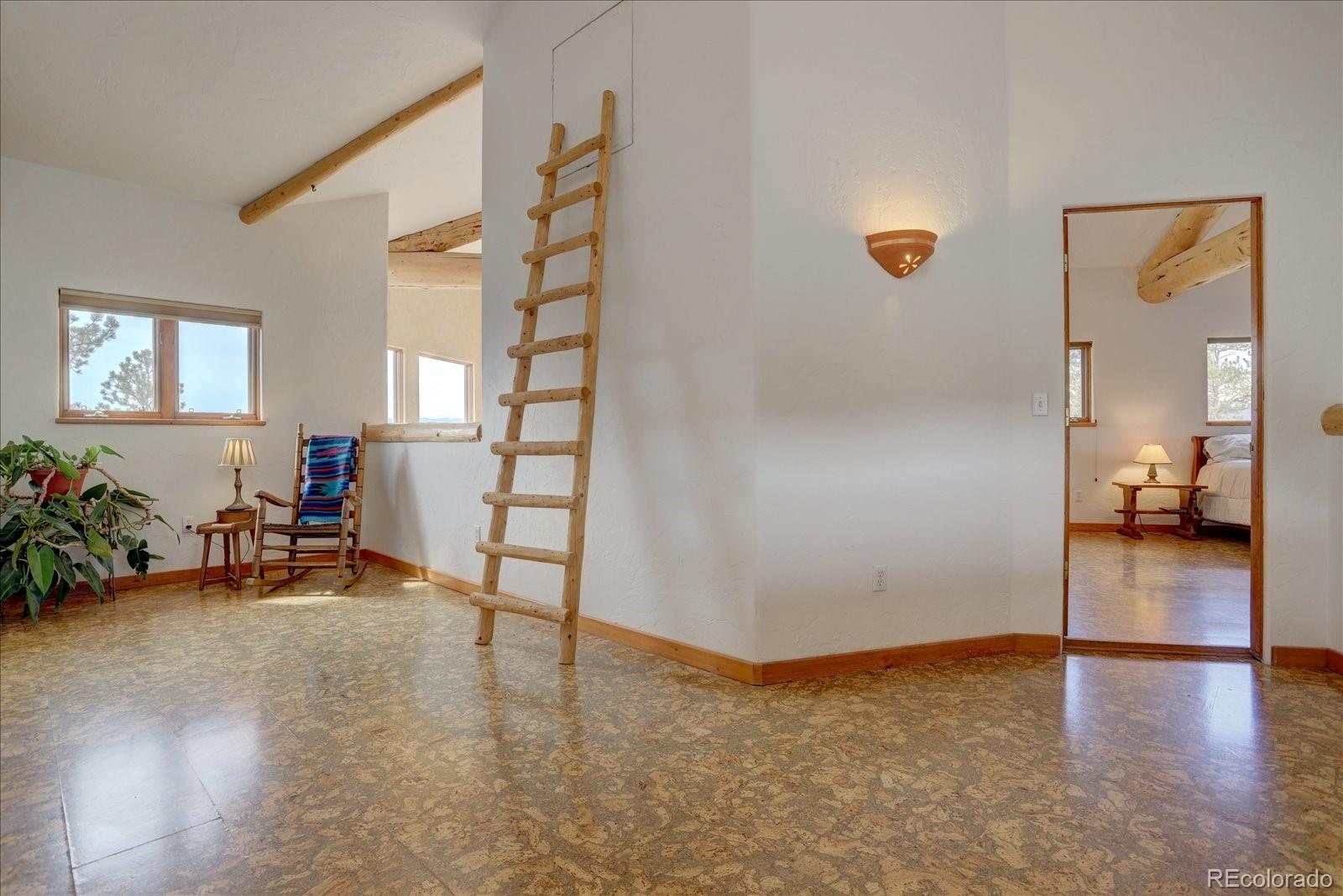 12227 Calfee Gulch Road Conifer, CO 80433 - Photo 20 of 43 a view of a livingroom with furniture and a hallway