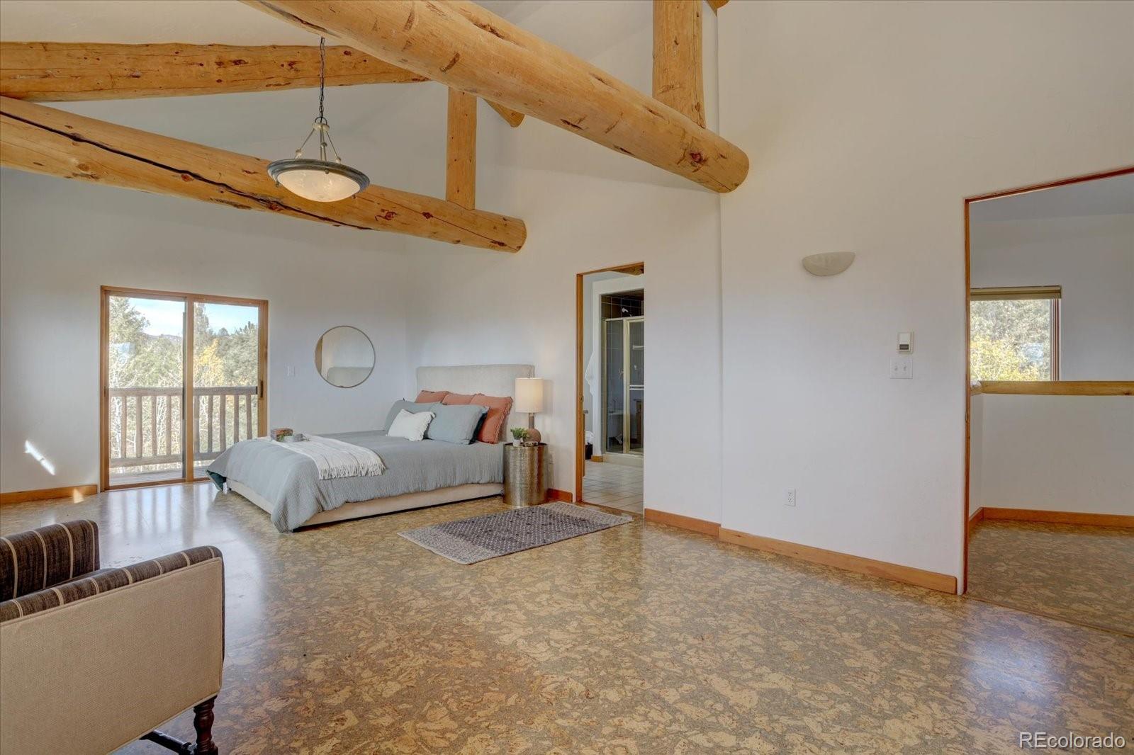 12227 Calfee Gulch Road Conifer, CO 80433 - Photo 23 of 43 a bedroom with furniture and a window