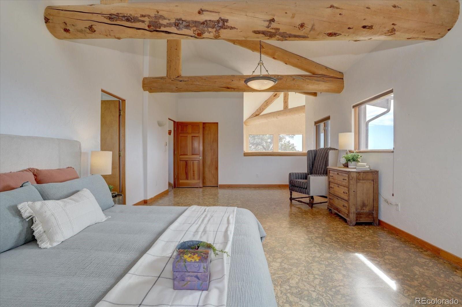 12227 Calfee Gulch Road Conifer, CO 80433 - Photo 24 of 43 a bedroom with furniture and a window