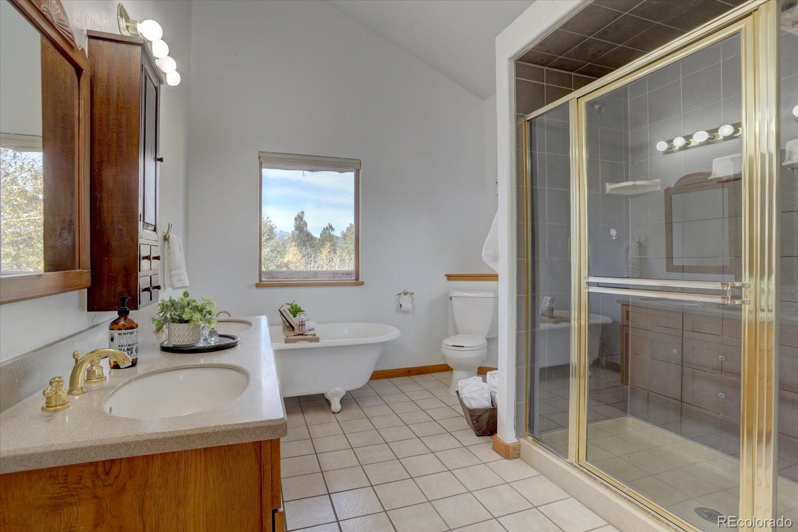 12227 Calfee Gulch Road Conifer, CO 80433 - Photo 26 of 43 a bathroom with a sink toilet and shower