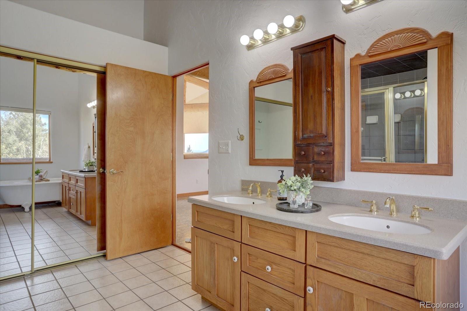 12227 Calfee Gulch Road Conifer, CO 80433 - Photo 28 of 43 a bathroom with a double vanity sink mirror and toilet