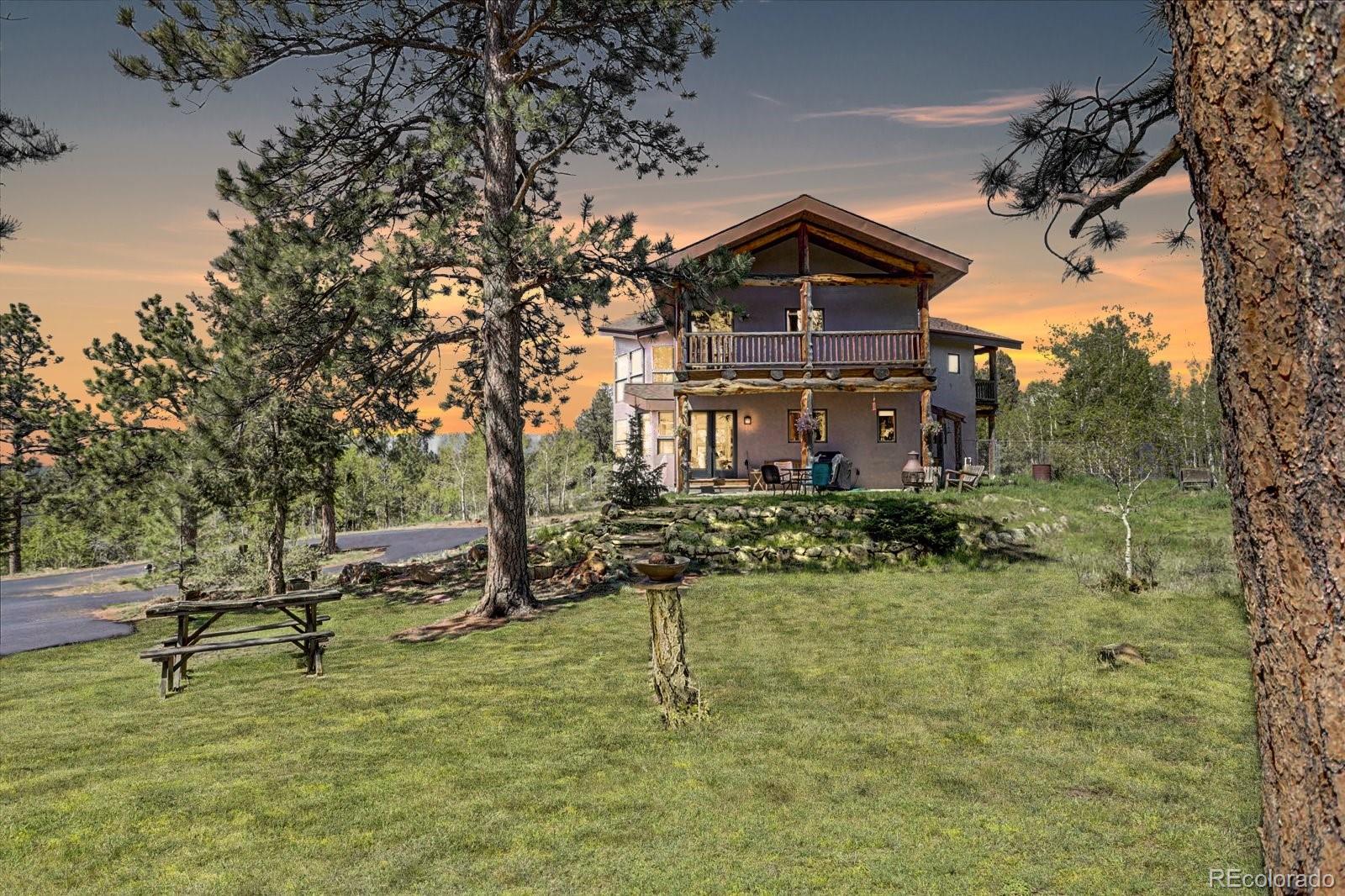 12227 Calfee Gulch Road Conifer, CO 80433 - Photo 3 of 43 a view of a house with a yard