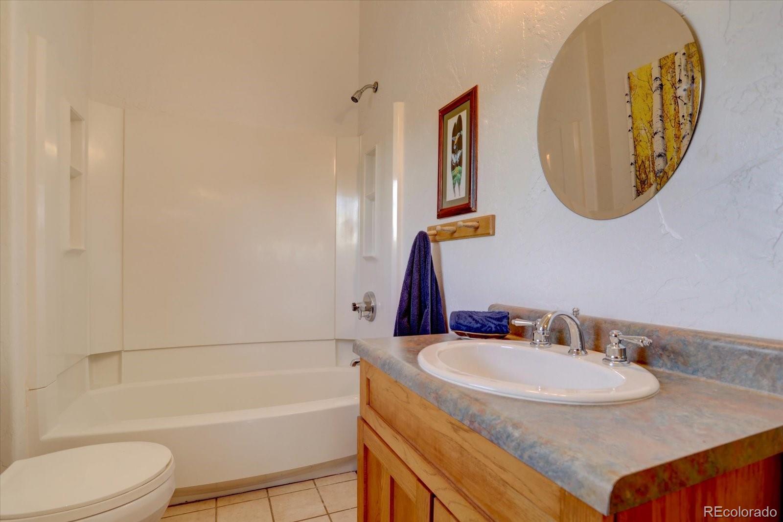 12227 Calfee Gulch Road Conifer, CO 80433 - Photo 31 of 43 a bathroom with a sink and a mirror