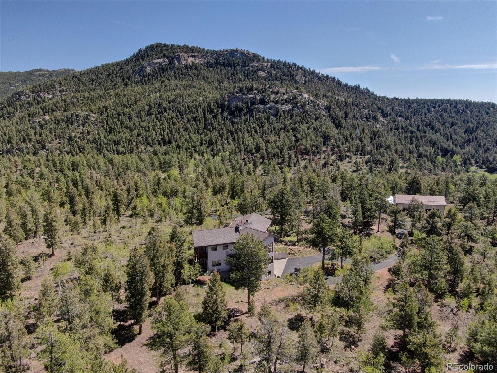 12227 Calfee Gulch Road Conifer, CO 80433 - Photo 41 of 43 a view of a houses with a yard