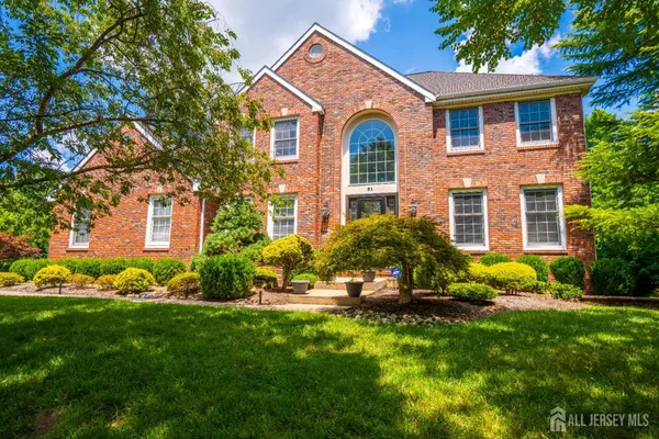 a front view of house with yard and green space